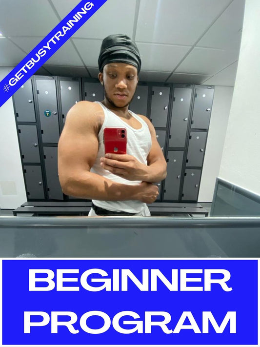 Coach Tyrese Standing in a Gym Mirror showing his Biceps! It's a banner for Beginner Program of GetBusyTraining